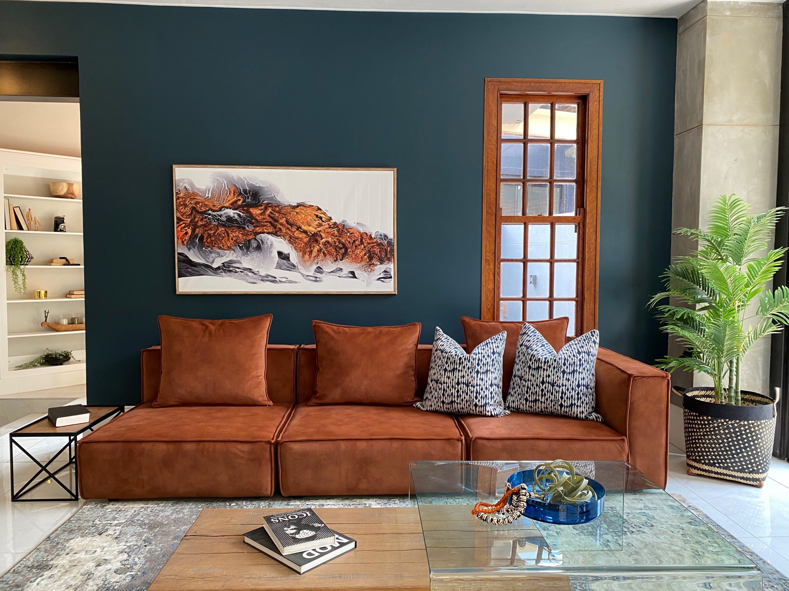 brown tan leather sofa couch with coffee table and wall art